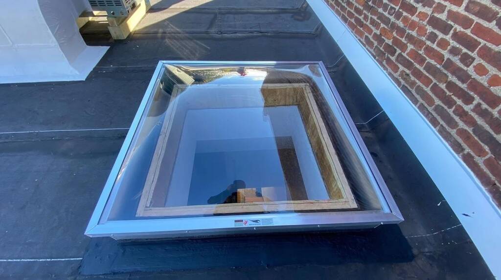 Skylight Leak Repair in NYC: Fix It Before Winter 1 Skylight curb and flashing on a flat NYC roof inspected for leaks