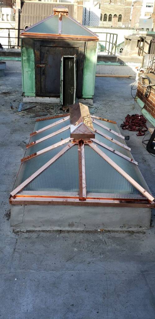 Skylight Leak Repair in NYC: Fix It Before Winter 3 Older pyramid skylight with copper framing on a Manhattan roof